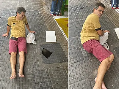 Homem cai e fica preso em buraco na calçada no centro de São Vicente
